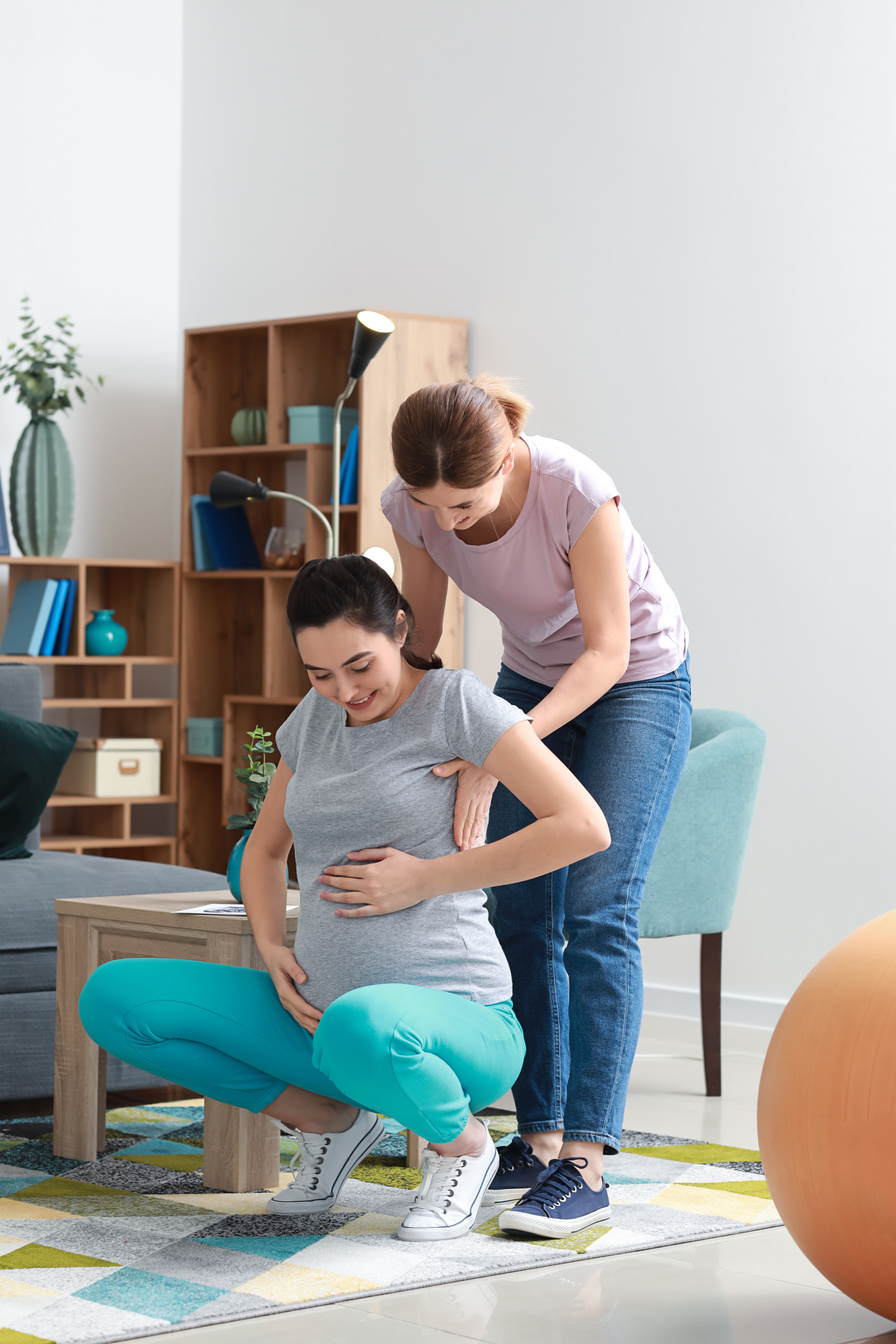 Doula and Pregnant Woman Doing Exercises at Home